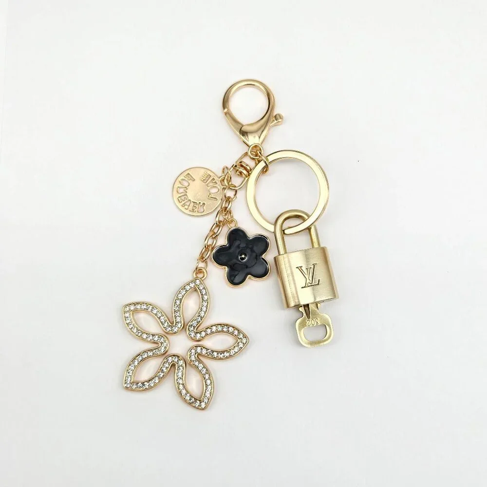 Louis Vuitton Gold-Tone Crystal Flower Keychain with Black Accent